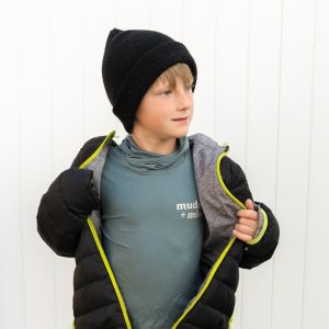 A young boy wearing a jacket and a hat